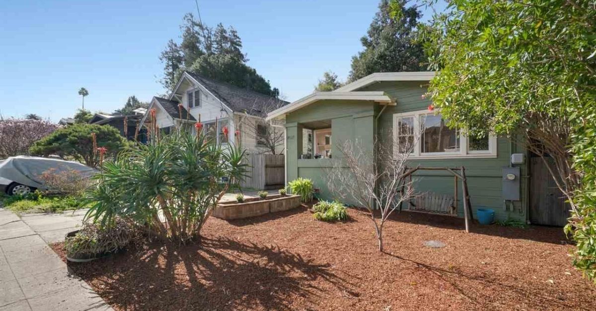 Exterior of green house with garden for sale in Oakland, California 