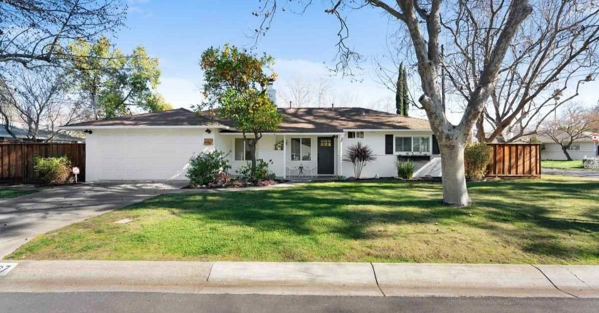 White Craftsman style home for sale in Pleasant Hill, California exterior shot with garage and garden