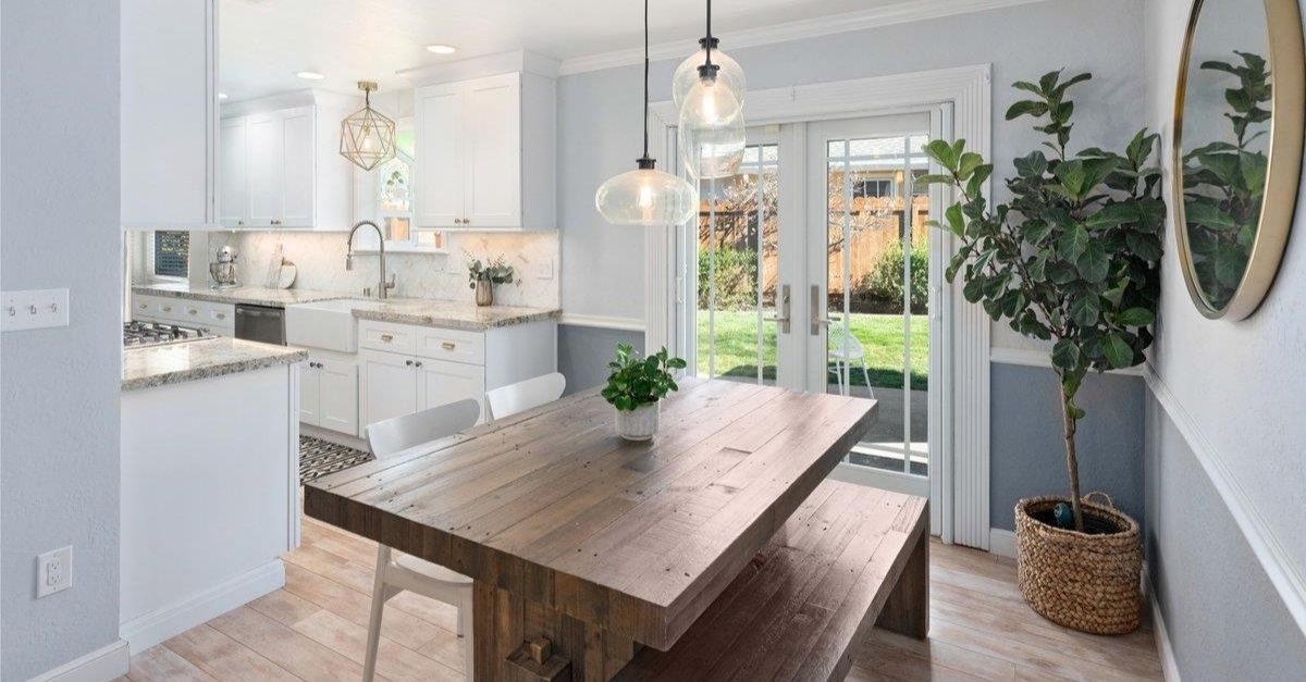 Interior of Craftsman style home in California with lovely kitchen and large dining table with bench 