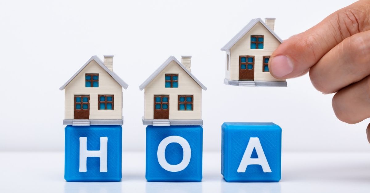 Image of little toy houses that say HOA under them
