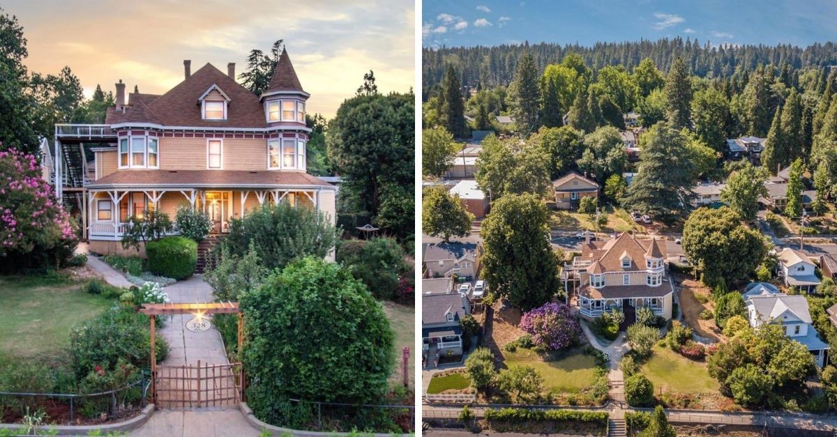 Beautiful tan colored Queen Anne style home surrounded by houses and trees