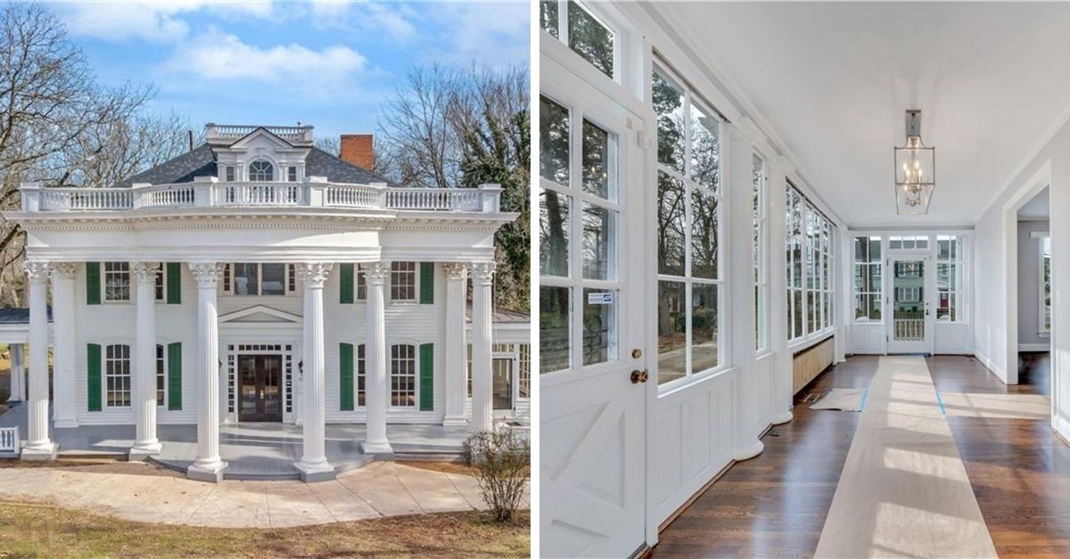 Huge white house with white columns and a large top floor balcony