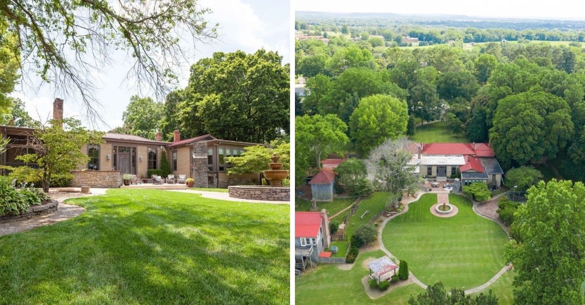 Stretching ranch style house with lots of greenery surrounding it