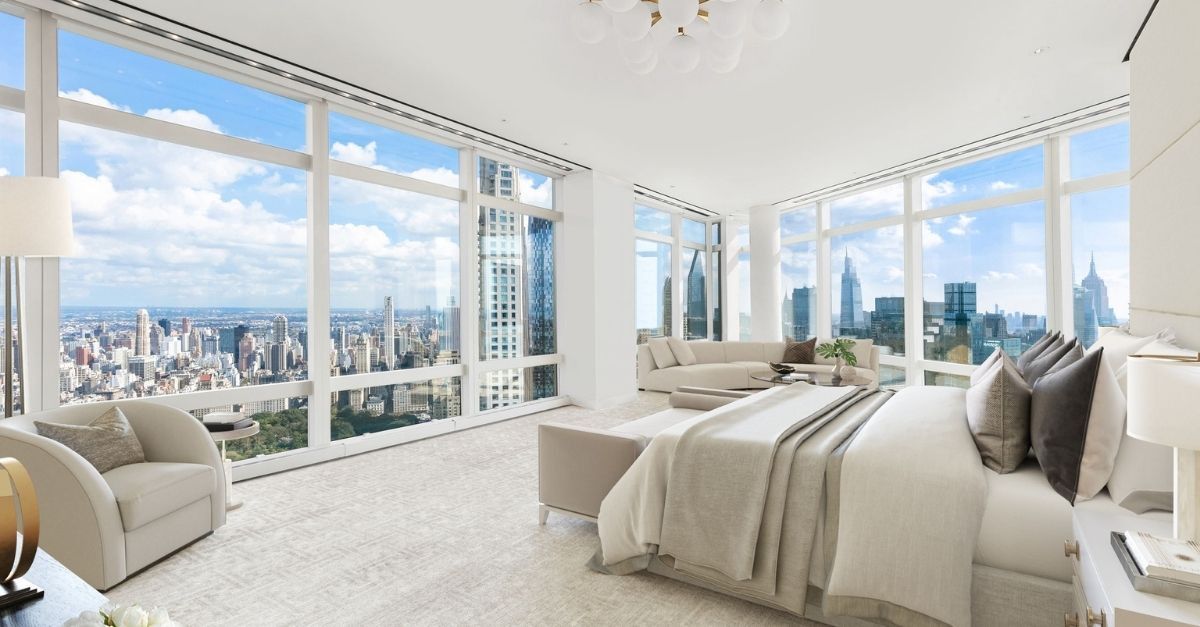 Large, white bedroom overlooking NYC