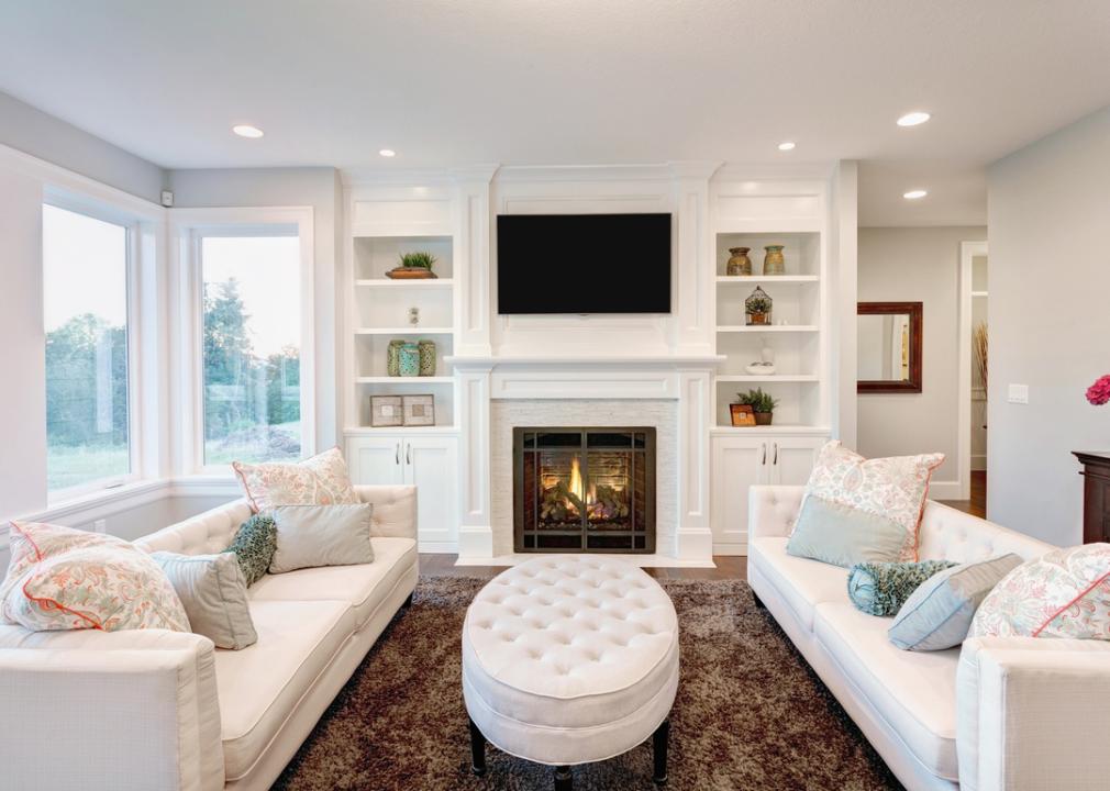 Fire lit in white living room
