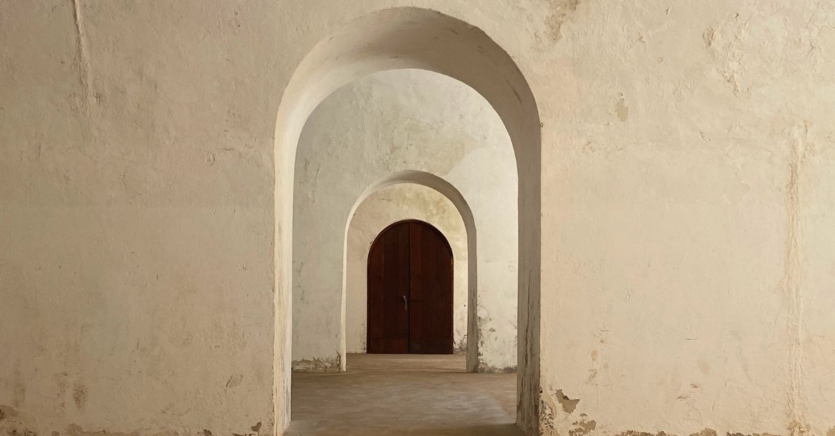 Archway leading to arched door
